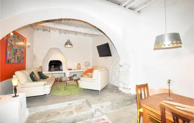 a living room with an archway and a fireplace at Gorgeous Home In Villeseque Des Corbier in Villesèque-des-Corbières