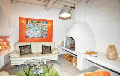 a living room with a couch and a fireplace at Gorgeous Home In Villeseque Des Corbier in Villesèque-des-Corbières