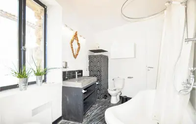a bathroom with a tub and a sink and a toilet at Gorgeous Home In Villeseque Des Corbier in Villesèque-des-Corbières