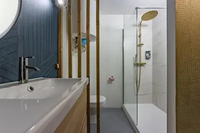 a bathroom with a sink and a shower at Solstice T2 Hypercentre SmartTV Wifi in Pamiers