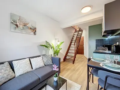 a living room with a couch and a table at Solstice T2 Hypercentre SmartTV Wifi in Pamiers