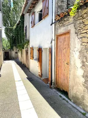 an alley with an old building with a wooden door at Cosy Camon Bolt-Hole in Camon