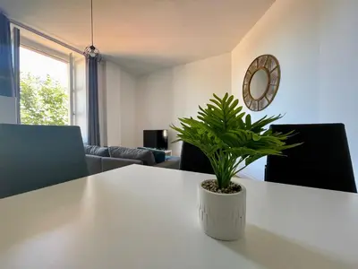 a dining room with a table and two chairs at Les appartements d'Arthur - Pont-Neuf in Carcassonne