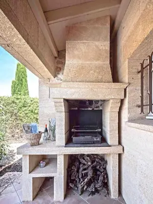a stone outdoor oven sitting on a patio at Belle villa moderne 3 chambres, jardins terrasse piscine in Durban-Corbières