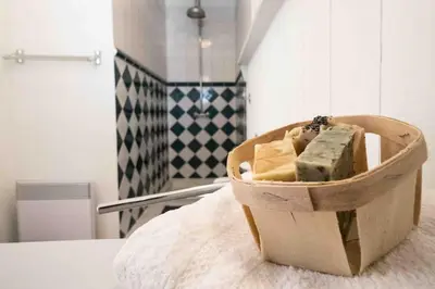 a box of cheese sitting on a bed at Belle villa moderne 3 chambres, jardins terrasse piscine in Durban-Corbières