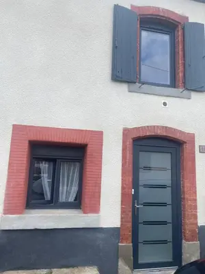 a building with two windows and a door at Propriétaire privé in Carcassonne