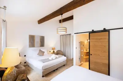 a bedroom with two beds and a sliding glass door at Longue Vie Au Roi - Vue Enchanteresse in Carcassonne