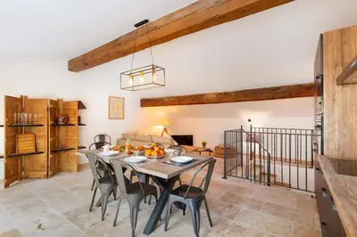 a kitchen and dining room with a table and chairs at Longue Vie Au Roi - Vue Enchanteresse in Carcassonne