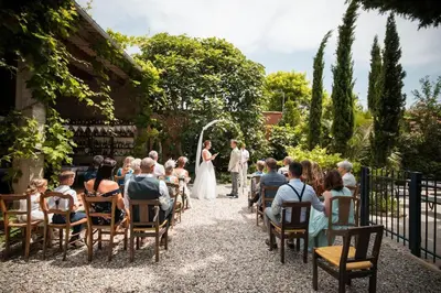 a bride and groom walking down the aisle at their wedding at Le Manoir d'Amiel a secret 16 bedroom garden oasis for groups up to 30 in Villegailhenc