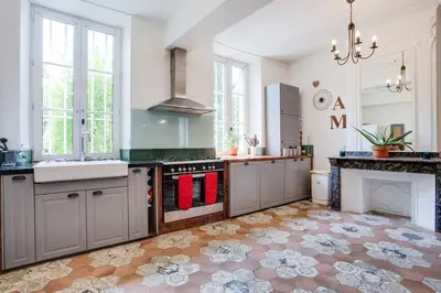 a bedroom with a bed and a fireplace at Le Manoir d'Amiel a secret 16 bedroom garden oasis for groups up to 30 in Villegailhenc