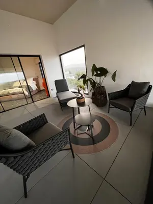 a living room with a couch and chairs and a table at Suite 28 in Treilles
