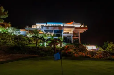a house on a golf course at night at Suite 28 in Treilles