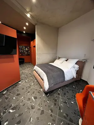 a bedroom with a bed and a flat screen tv at Suite 28 in Treilles