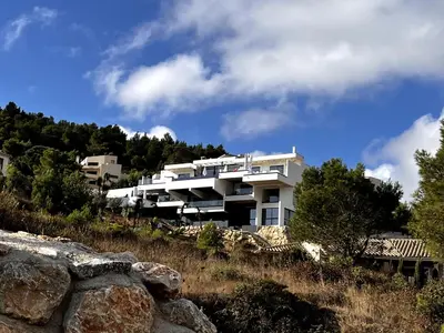 a white building on top of a hill at Suite 28 in Treilles