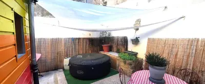 a small patio with a table and a tent at Le 100 in Carcassonne