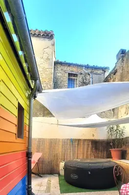 a patio with awning and a bag on the ground at Le 100 in Carcassonne