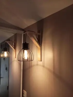 two lights on a wall in a room at Le Mas Rose in Villeneuve-lès-Montréal