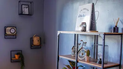 a shelf with a clock and a bike on it at Carcalove - Pool, Billard & Jacuzzi - 10pax in Fontiès-dʼAude