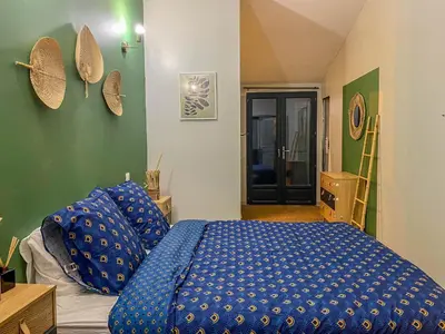 a bedroom with a blue bed with blue pillows at Carcalove - Pool, Billard & Jacuzzi - 10pax in Fontiès-dʼAude