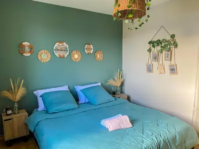 a blue bed with blue pillows and plates on the wall at Carcalove - Pool, Billard & Jacuzzi - 10pax in Fontiès-dʼAude