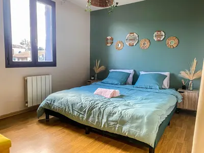 a bedroom with a large bed with blue sheets at Carcalove - Pool, Billard & Jacuzzi - 10pax in Fontiès-dʼAude