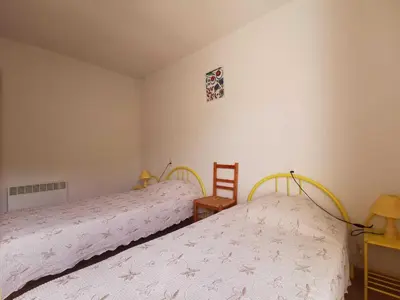 a bedroom with two beds and a table and a desk at Rouvenac in Trilla