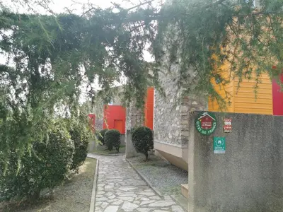 a walkway in front of a building with trees at Lou soula in Trilla