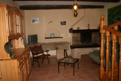 a living room with a fireplace and a television at Domaine du coude in Saint-André-de-Roquelongue