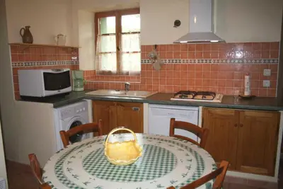 a kitchen with a table with a yellow bag on it at Domaine du coude in Saint-André-de-Roquelongue