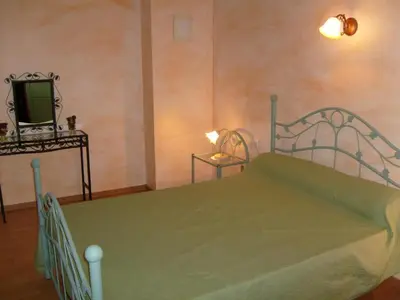 a bedroom with a bed and a tv in it at Domaine du coude in Saint-André-de-Roquelongue