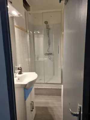 a bathroom with a shower and a sink at La cabane bleue à Narbonne in Narbonne