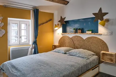 a bedroom with a large bed with stars on the wall at Place Carnot - studio tout équipé avec jacuzzi proche toutes commodités in Carcassonne
