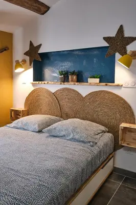 a bedroom with a large bed with stars on the wall at Place Carnot - studio tout équipé avec jacuzzi proche toutes commodités in Carcassonne