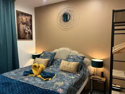 a room with a bed with a stuffed animal on it at La CORSA CHAMBRE FAMILIALE DELUXE in Narbonne