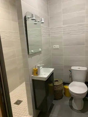 a bathroom with a toilet and a sink and a mirror at LA DI MARIA in Narbonne