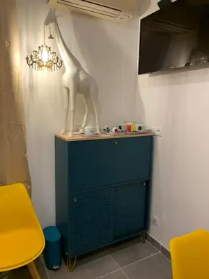 a giraffe statue sitting on top of a blue cabinet at LA DI MARIA in Narbonne