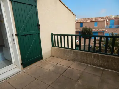 a green door on the side of a building at Villa à 50 m de la plage du Grazel pour 6 personnes in Gruissan