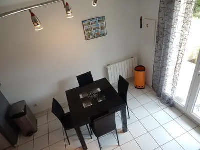 a dining room with a black table and chairs at Villa à 50 m de la plage du Grazel pour 6 personnes in Gruissan