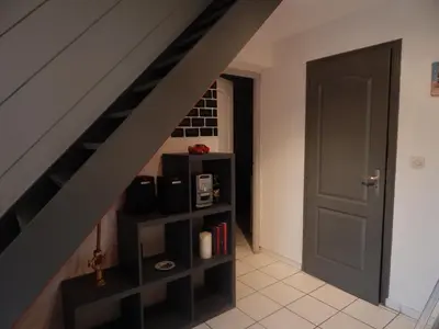a room with a staircase with a shelf under the stairs at Villa à 50 m de la plage du Grazel pour 6 personnes in Gruissan