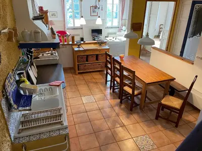 a kitchen with a table and a table and chairs at Große Ferienwohnung am Canal du MIDI mit Dachterrrasse in Homps