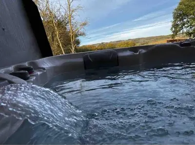 a hot tub filled with water in a truck at Gite à la ferme avec jacuzzi et piscine chauffée in Saint-Félix-de-Tournegat