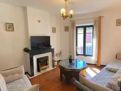 a living room with a fireplace and a tv at La Maison des Templiers ~ Ostal Médiéval ~ Logis enchantés in Carcassonne