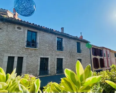 a building with windows and a blue ball in the sky at La Maison des Templiers ~ Ostal Médiéval ~ Logis enchantés in Carcassonne