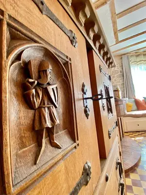a wooden door with a carving of a person on it at La Maison des Templiers ~ Ostal Médiéval ~ Logis enchantés in Carcassonne