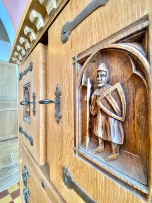 a wooden door with a carving of a woman on it at La Maison des Templiers ~ Ostal Médiéval ~ Logis enchantés in Carcassonne