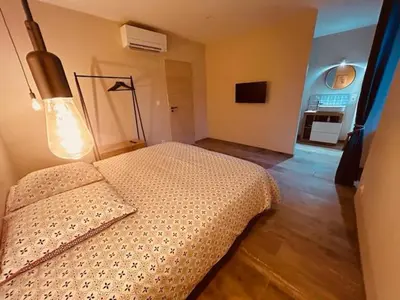 a bedroom with a bed and a lamp in it at Gites entre 2 rives in Montolieu