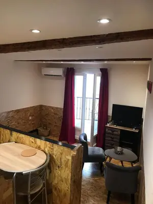 a living room with a desk and a table and chairs at New Boat in Narbonne