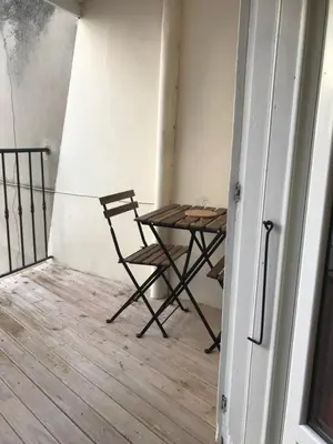 a table and a chair in a room with a table at New Boat in Narbonne