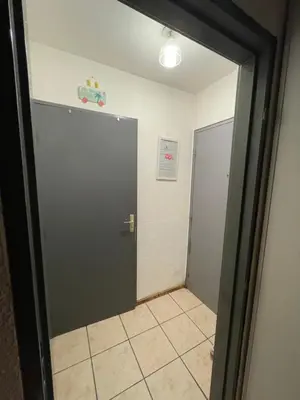 a door leading into a hallway with a tile floor at Narbonne centre T2 avec jardinet et parking in Narbonne