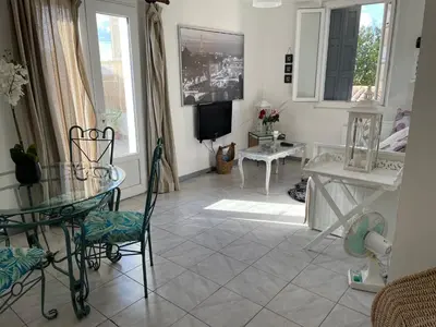 a small kitchen with a stove and a sink at Centre Carcassonne apartment with private sunny terrace in Carcassonne
